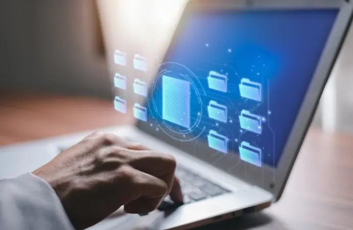 A person working on a laptop against a blue background, symbolizing ServiceNow implementation.